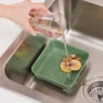 Refreshing glass of flavored water being rinsed in kitchen sink - easy home hydration.