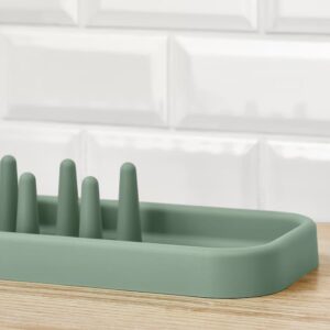 Silicone dish drying rack for kitchen organization, green color.