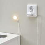 Power outlet with charger connected for charging electronic devices, modern home energy solutions.