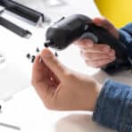 Screwdriver in hand, assembling gadgets for online shopping at OKDEALS.