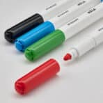 Colorful marker pens for whiteboard and classroom use, ideal for office and educational purposes.