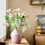 Beautiful flower arrangement in a pink vase for home decoration.