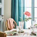 Vase with pink flower on a cozy dining table for home decor, stylish and perfect for online shopping.