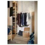 Organized wardrobe with hanging clothes and storage shelves.