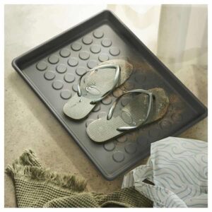 Dirty flip flops left on a moldy, waterlogged tray.