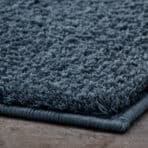 High-quality soft blue textured rug for home decor, ideal for living rooms and bedrooms.