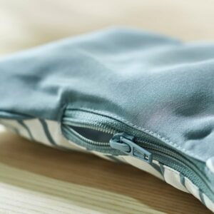 Blue and white striped ANTILOP cushion cover with zipper detail.