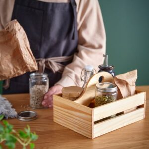 Wooden kitchen organizer with jars and utensils for storage.