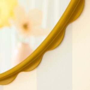 Dark yellow DAGGKAPRIFOL mirror with scalloped edge design.