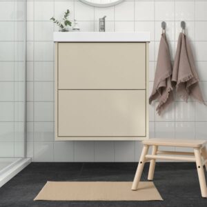 FINTSEN beige bath mat in modern bathroom setting.