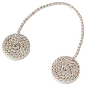 Beige and white magnetic curtain tie-back for window decor.