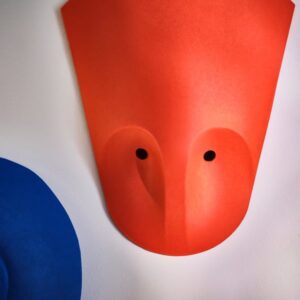 Colorful wall decoration with pink, red, and blue elements for modern interior decor.