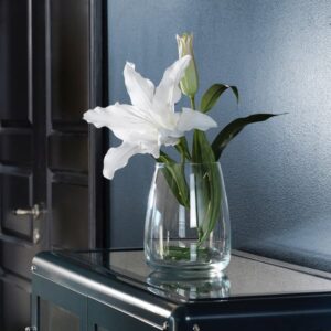 White lily artificial flower in glass vase for home decor.