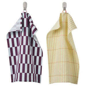 Two patterned tea towels hanging on hooks, one with purple checkered design, the other with yellow-1.