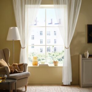 Bright living room with beige curtains and natural sunlight.