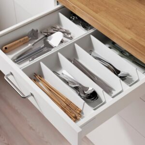Organized kitchen drawer with VARIERA utensil tray and cutlery.